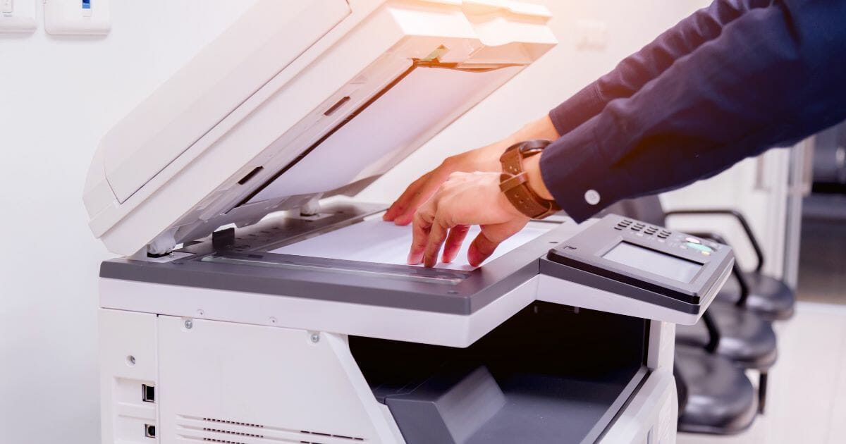close-up bussines man hand press button on panel of printer,printer scanner laser office copy machine supplies start concept
