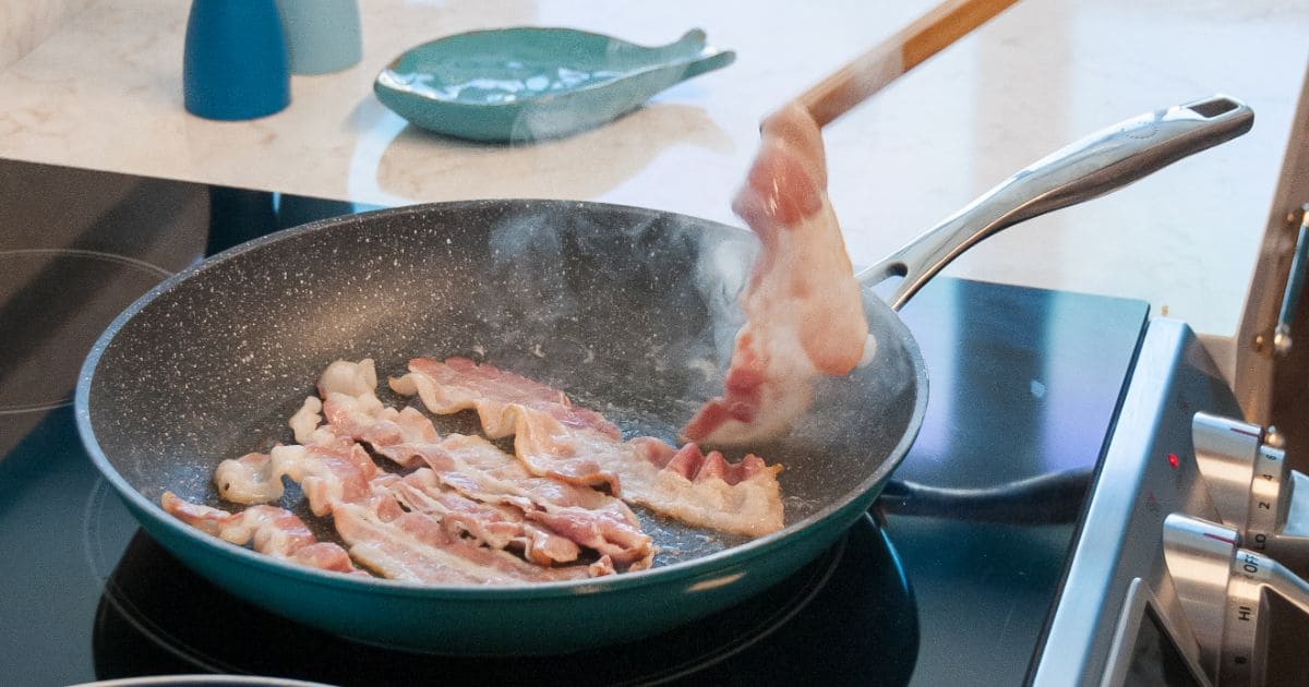 bacon cooking on fry pan